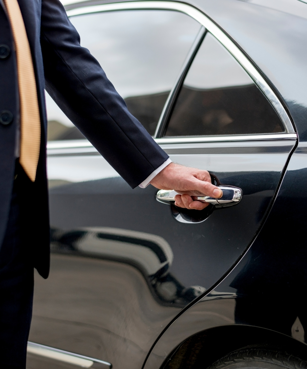 Executive Tours chauffeur opening a car door for a client